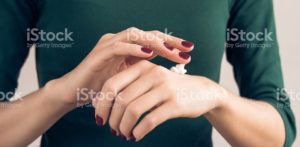 maroon manicure applying hand cream